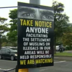 BBC A poster that reads 'Take notice anyone facilitating the settlement of Muslims or illegals in our areas will be held responsible. We are watching' it also has a picture of a persons eyes along the top of the poster.